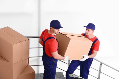 Professional movers transporting furniture in Streatham